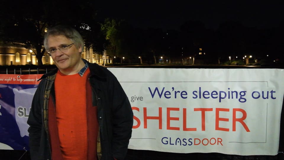 Jeremy Smith, one of the sleepers this year, standing next to a Sleep Out banner